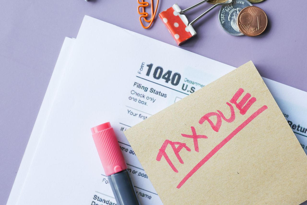 The Art of Drawing Readers In: Your attractive post title goes here Close-up of IRS Form 1040 with 'Tax Due' note and stationery on a desk.
